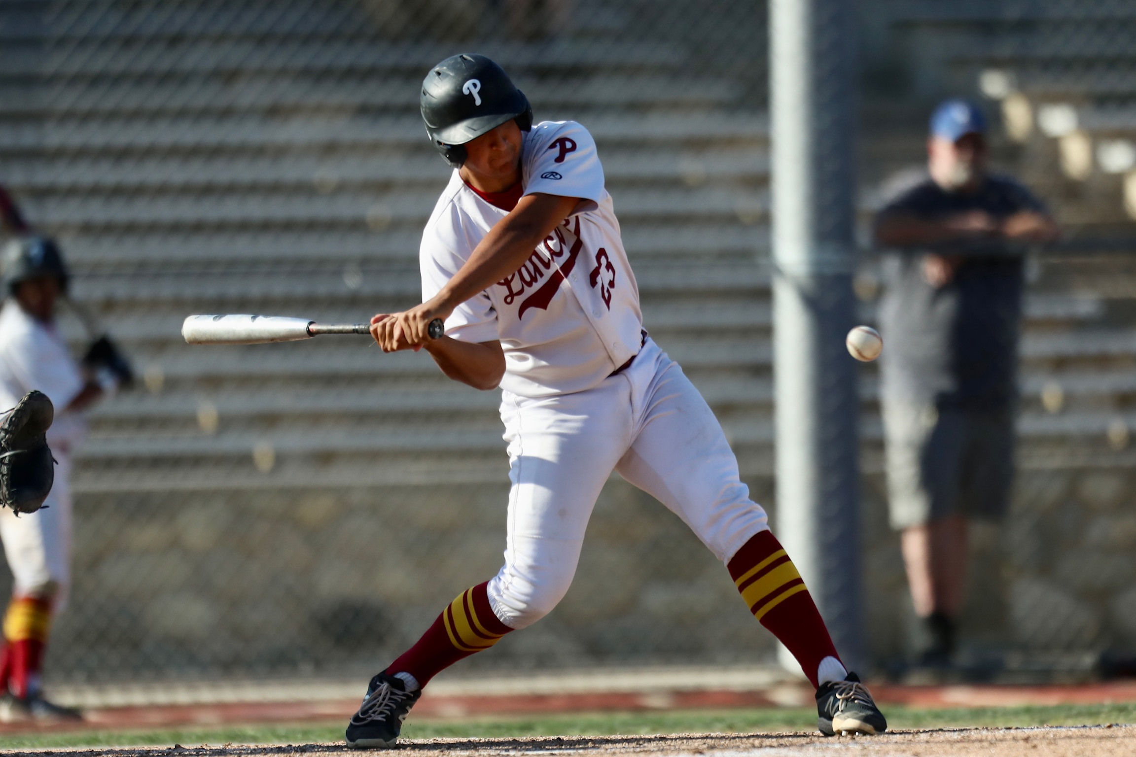 Catcher Matthew Delgado backstopped Wednesday's shutout as he swings for a hit (photo by Michael Watkins, PCC Athletics).