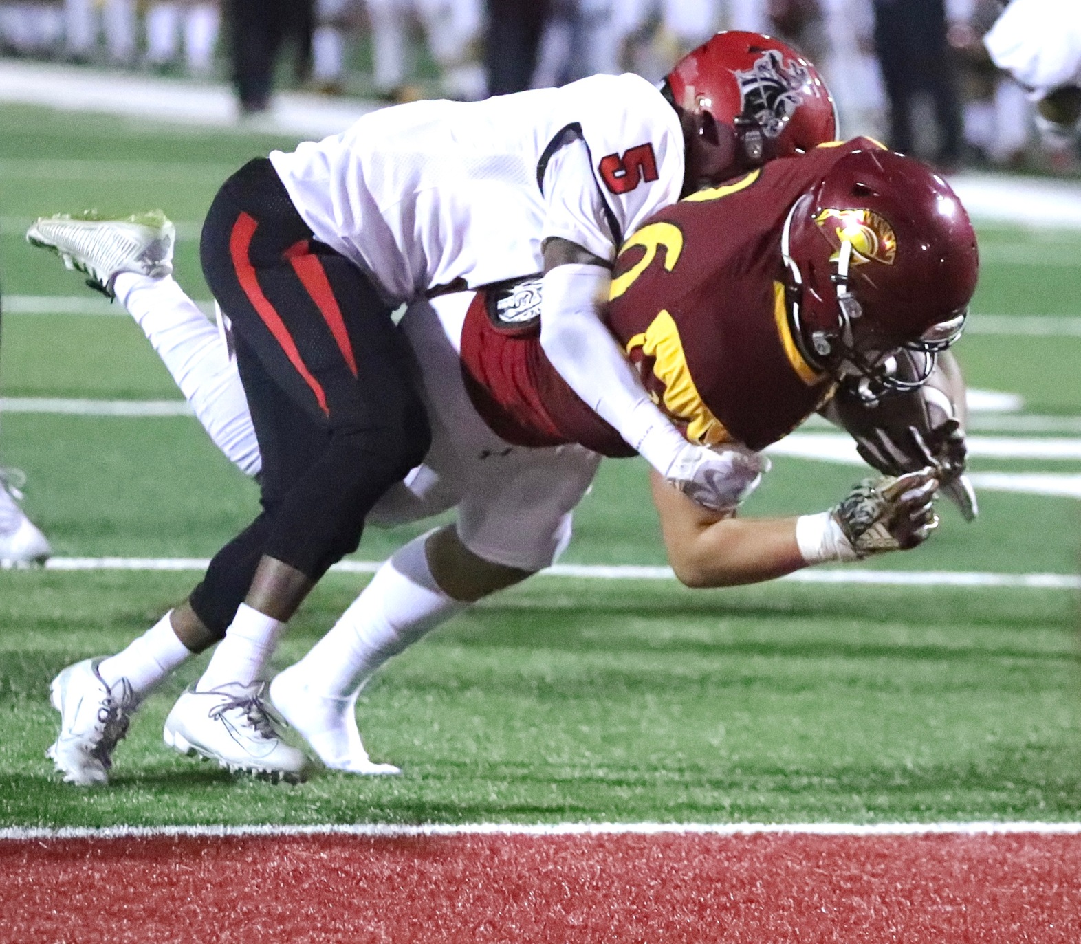 Lancer Salman Gurung dives into end zone for one of his two touchdowns in Saturday's football victory, photo by Michael Watkins.