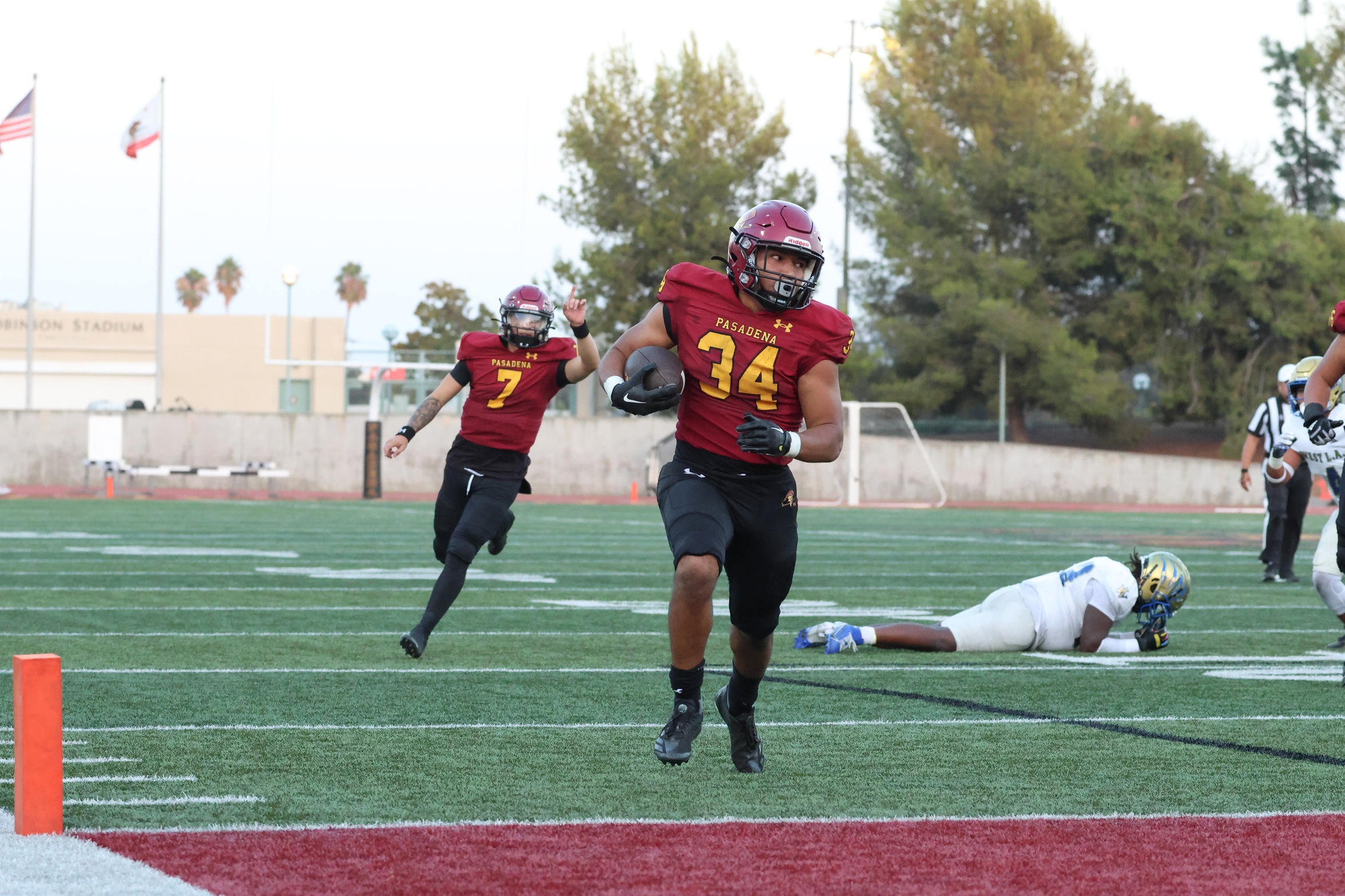 Micah Mendoza breaks free for one of his three touchdowns on Saturday (photo by Richard Quinton).