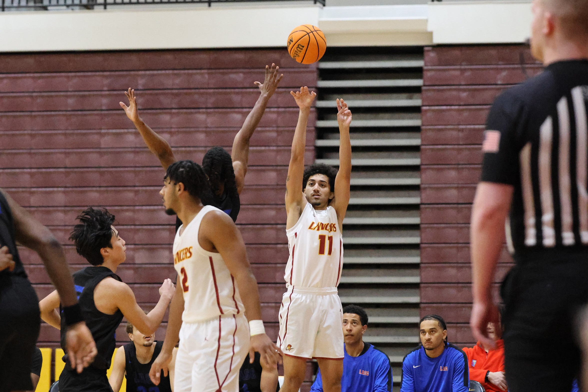 Julian Thompkins sinks the bomb in Friday's win (photo by Richard Quinton).