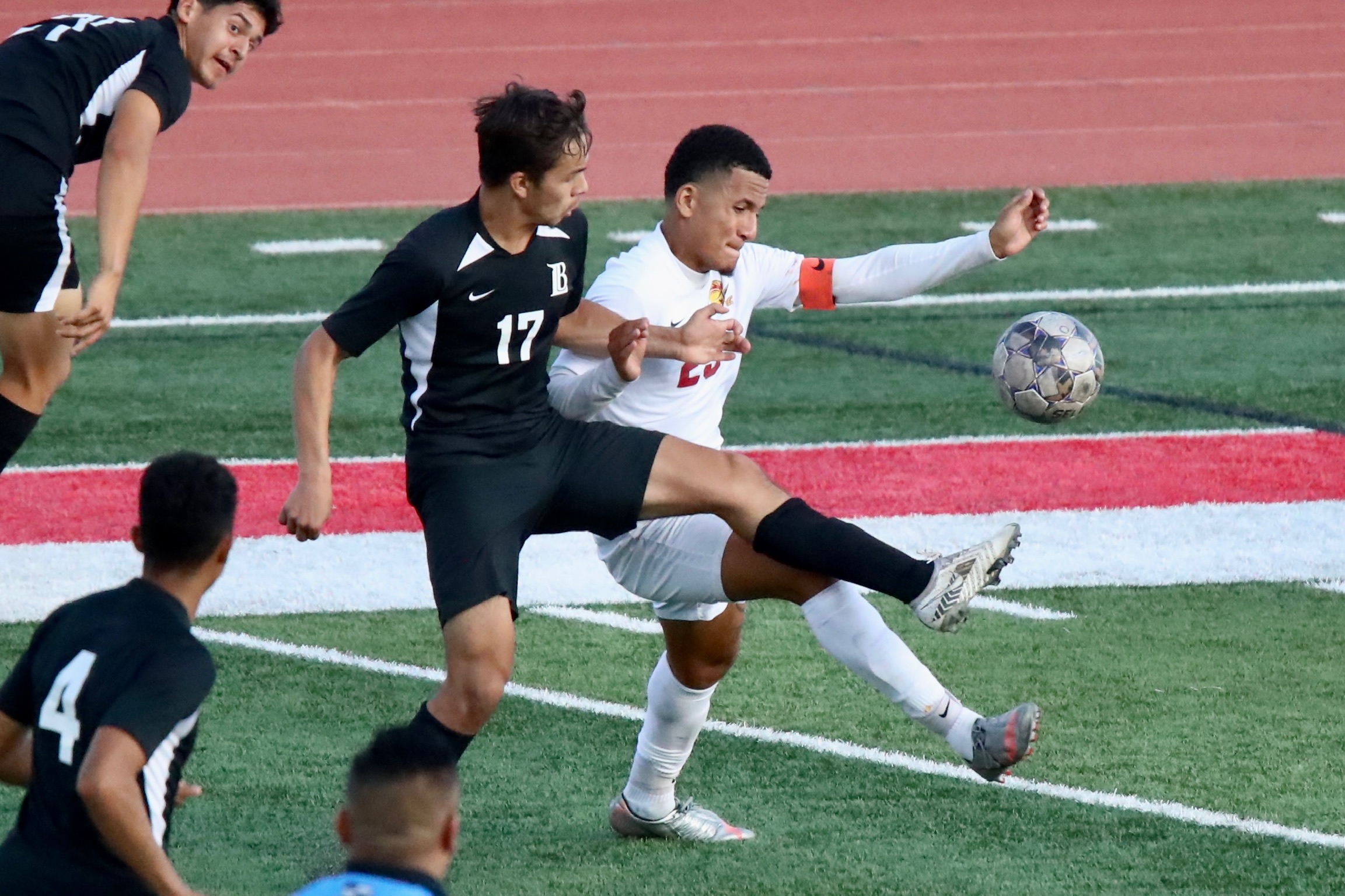 Sophomore Cameron Montana (white jersey) has played superlative defense for the Lancers this season (photo by Michael Watkins).