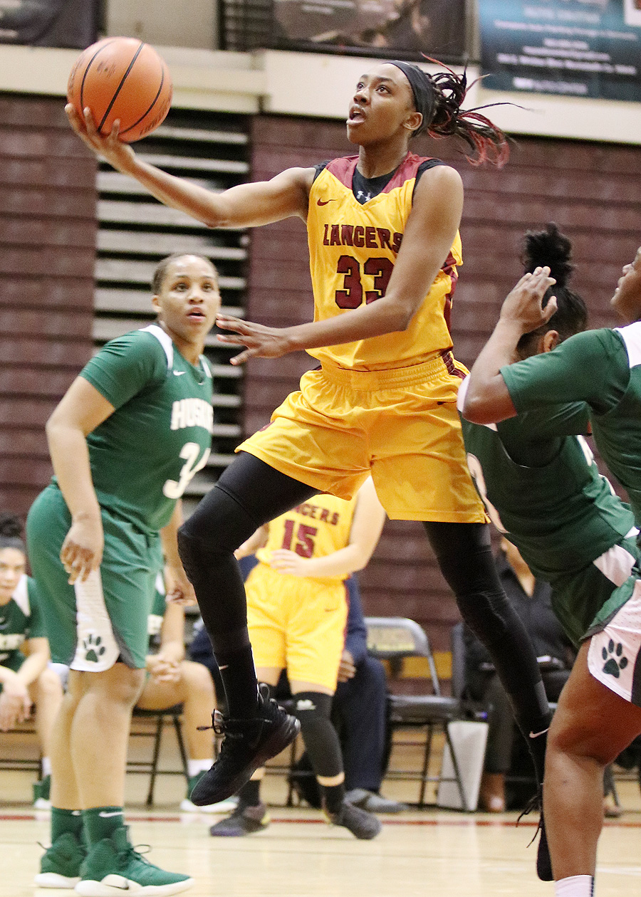Lancer Dariel Johnson continues to be one of the state's most prolific players. She goes up for a shot in Friday's loss v. East LA, photo by Richard Quinton.