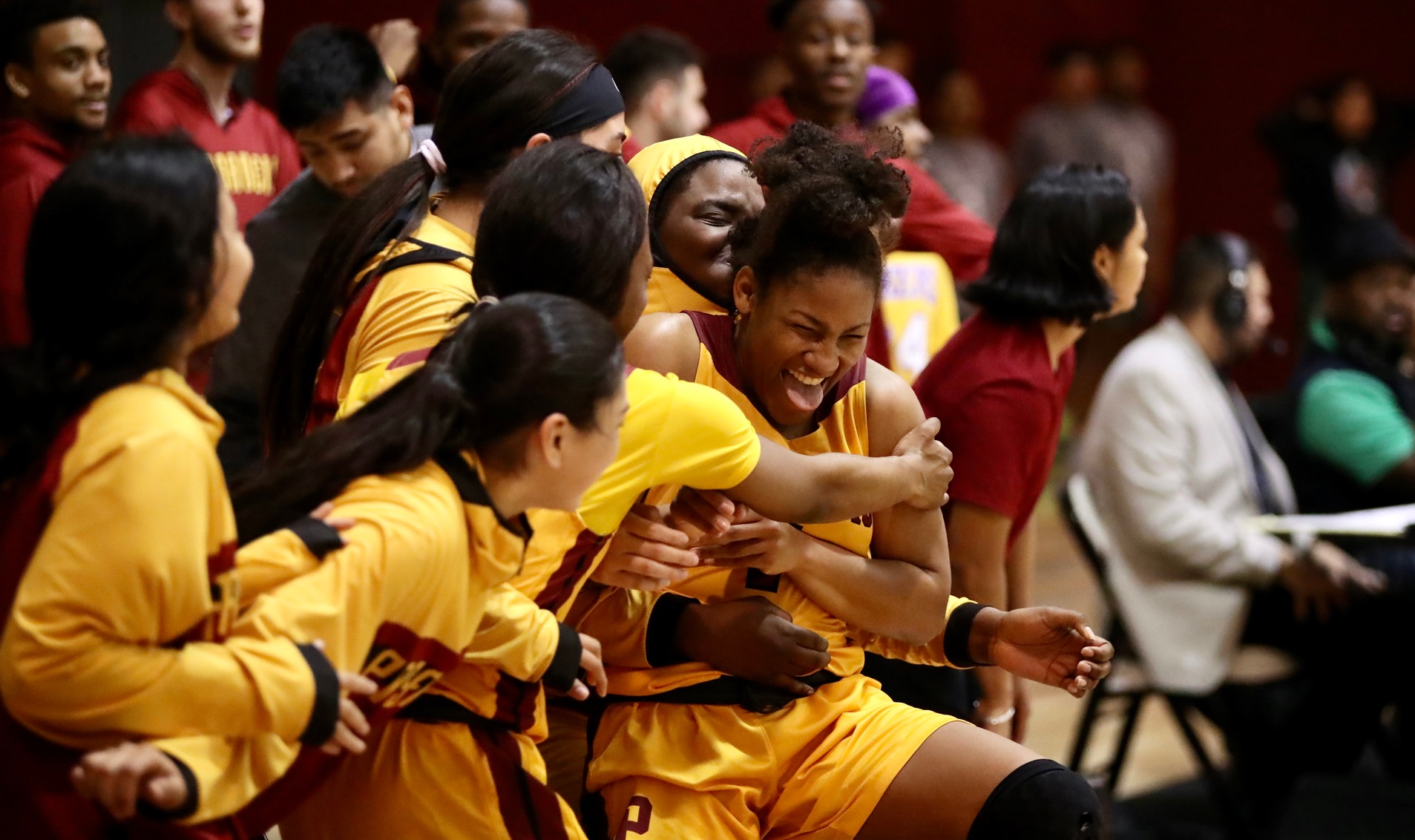 Cosette Balmy is mobbed by teammates after her overtime basket during the Lancers win over East LA, photo by Michael Watkins.