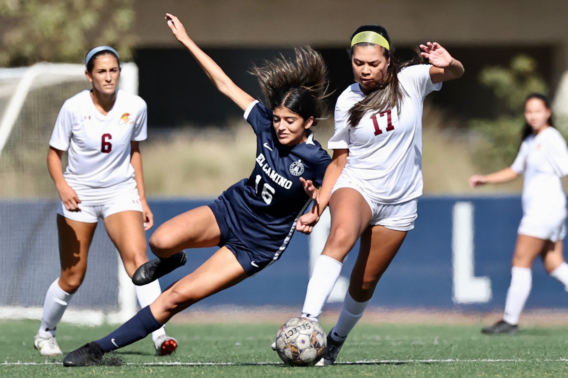 Isabel Guerrero brings the ball past an El Camino defender with Gabby Morales looking on during the SCC Tournament on Nov. 4 (photo by Michael Watkins).