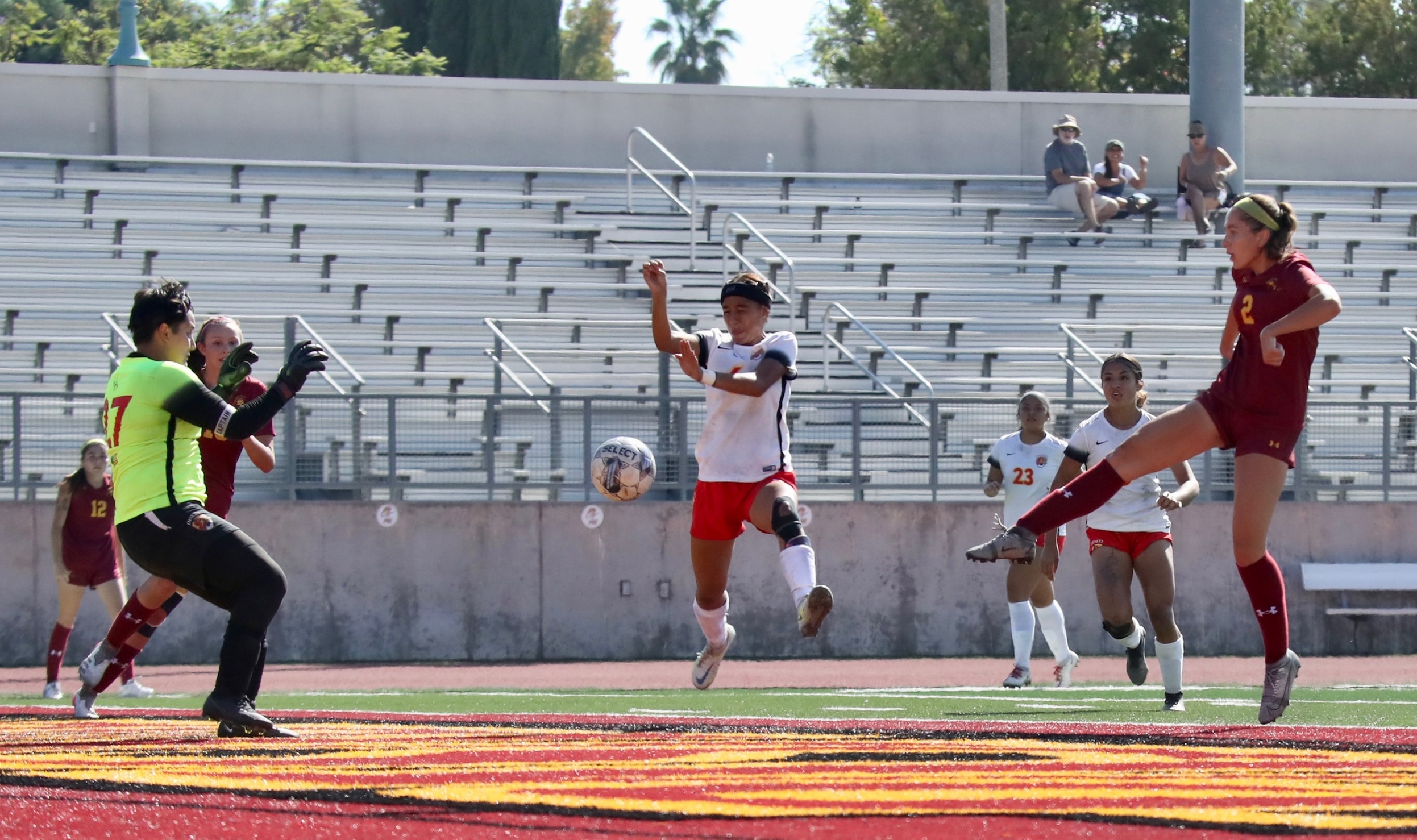 Olivia Aguilar goes airborne to drive this shot in Friday's win over Desert (photo by Michael Watkins).