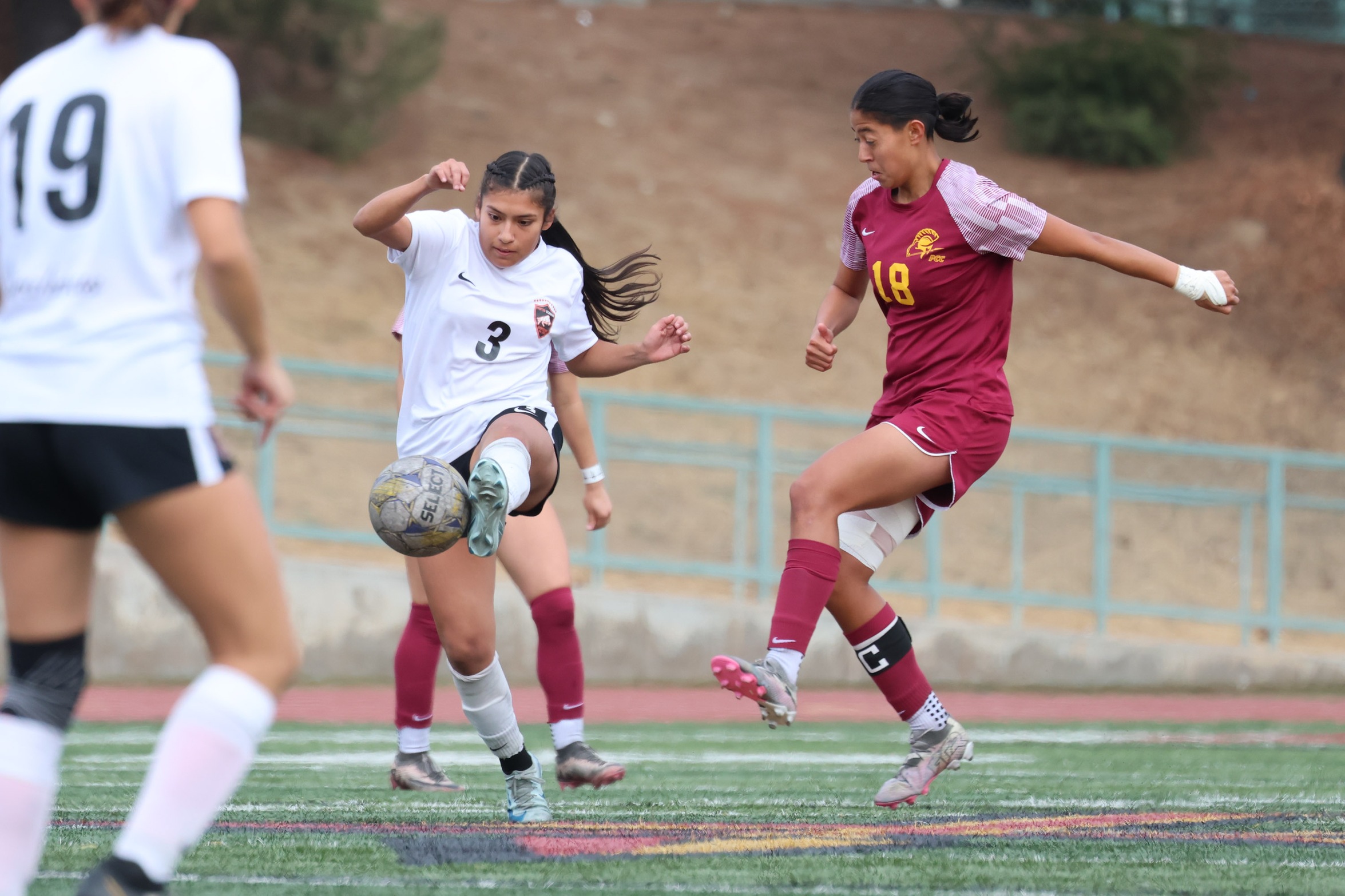 Itzel Nunez plays the ball v. a Pierce forward in Saturday's playoff (photo by Richard Quinton).
